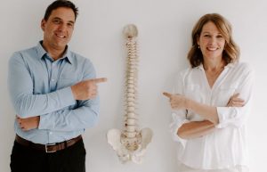 Dr. Laina and Dr. Jamie pointing at the spine
