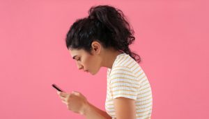Woman on her phone in poor posture