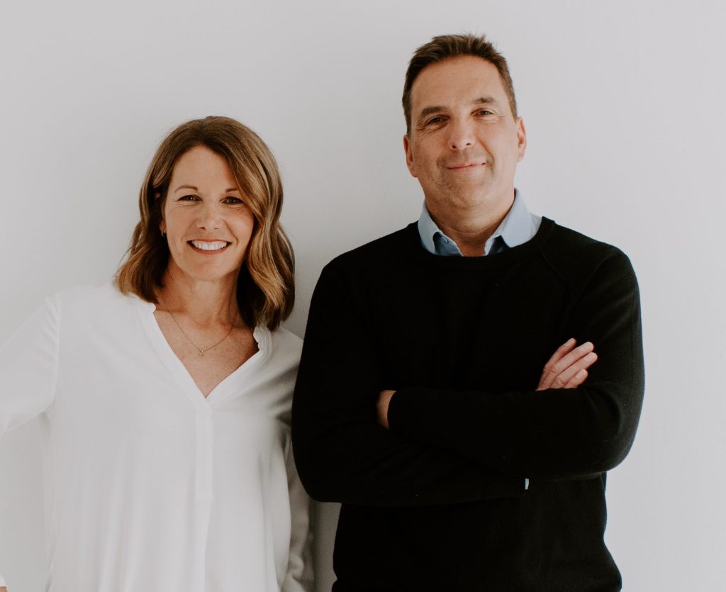 2 chiropractors, a male in a black shirt and a female in white