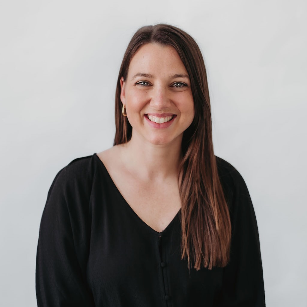 Naturopath in a black V-neck sweater smiling