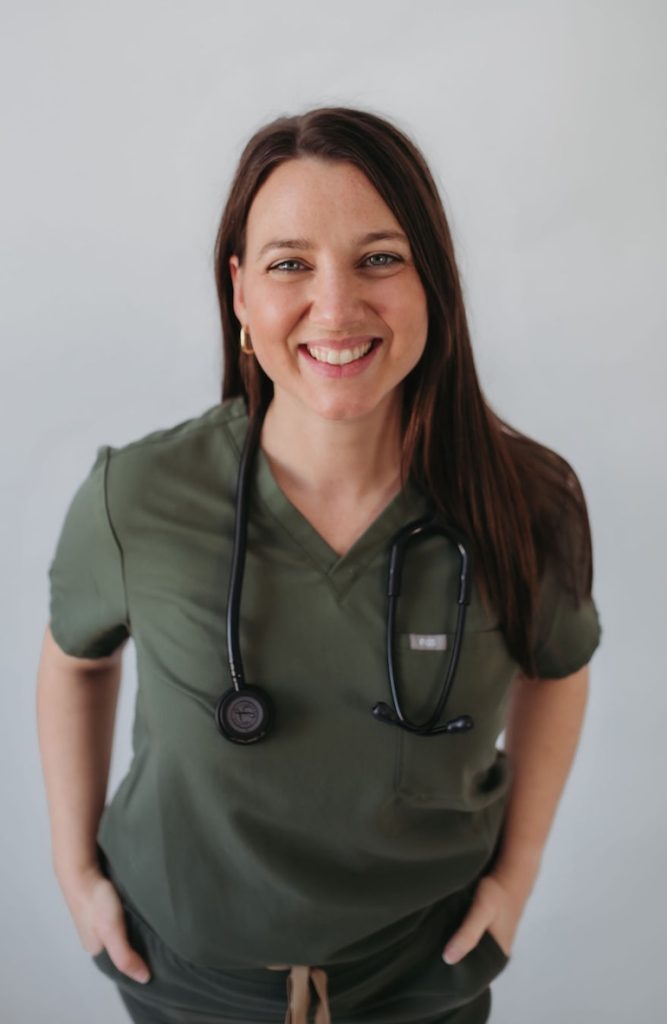 Naturopath Raquel in greens smiling with stethescope around her neck