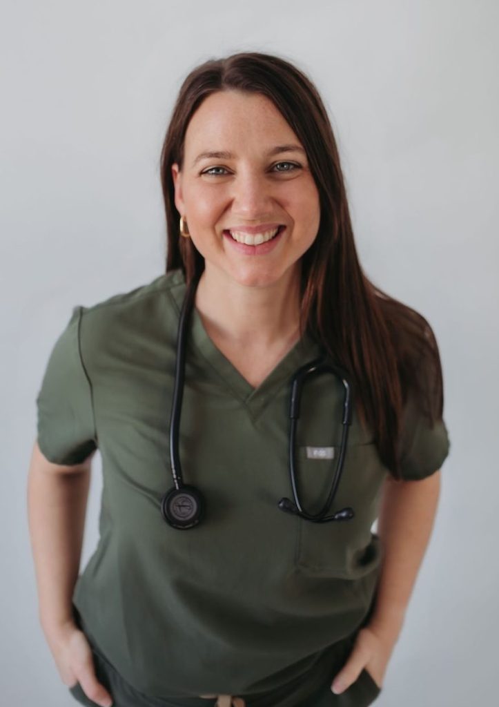 Naturopath Raquel in greens smiling with stethescope around her neck